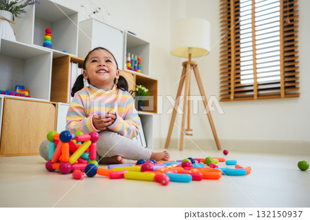 toddler girl playing colorful magnetic construction toy toddler girl playing colorful magnetic construction toy 132150937