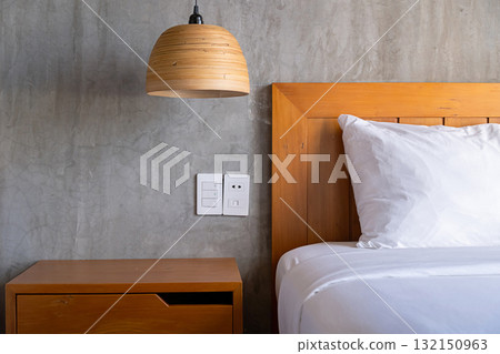 Modern hotel room design with comfortable bed, bedside table and industrial style concrete wall. Modern hotel room design with comfortable bed, bedside table and industrial style concrete wall. 132150963
