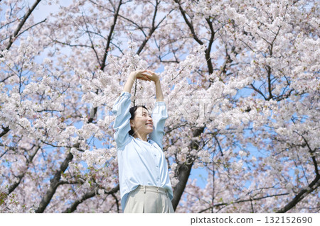 A woman stretching in front of cherry blossoms A woman stretching in front of cherry blossoms 132152690