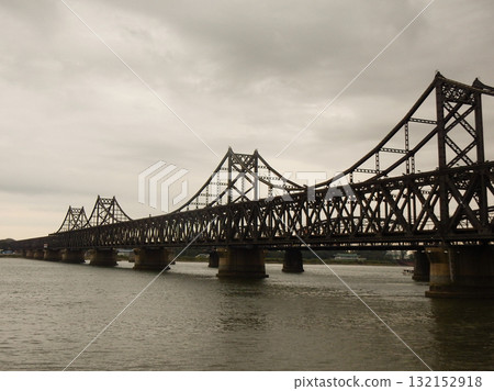 Sino-Korean Friendship Bridge across the Yalu River. It crosses from Dandong in China to Sinuiju in North Korea. Sino-Korean Friendship Bridge across the Yalu River. It crosses from Dandong in China to Sinuiju in North Korea. 132152918