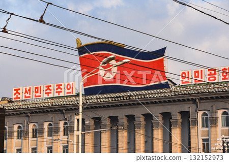 The North Korean flag above Kim Il Sung Square in Pyongyang, North Korea The North Korean flag above Kim Il Sung Square in Pyongyang, North Korea 132152973