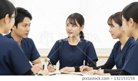 Caregivers sharing information at a team meeting 132153158