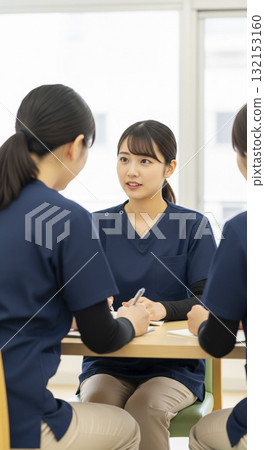 Caregivers sharing information at a team meeting Caregivers sharing information at a team meeting 132153160