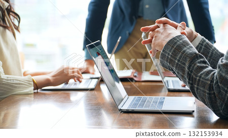 Group of casual business people meeting in an office Group of casual business people meeting in an office 132153934