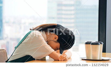 A restaurant employee worried inside the store 132154029
