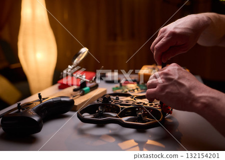 User Engaging in the Repair and Restoration of a Device Comprehensive Electronics Work User Engaging in the Repair and Restoration of a Device Comprehensive Electronics Work 132154201