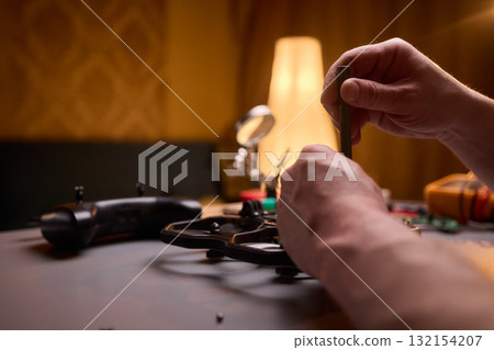 User Engaging in the Repair and Restoration of a Device Comprehensive Electronics Work User Engaging in the Repair and Restoration of a Device Comprehensive Electronics Work 132154207