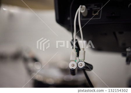 A detailed closeup of audio equipment that is being connected to drums for a performance A detailed closeup of audio equipment that is being connected to drums for a performance 132154302