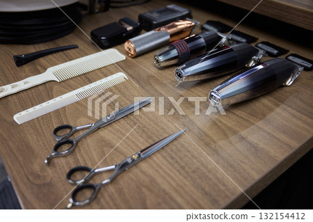 Professional Hair Cutting Tools Organized Neatly on a Barbers Workbench Ready for Use 132154412