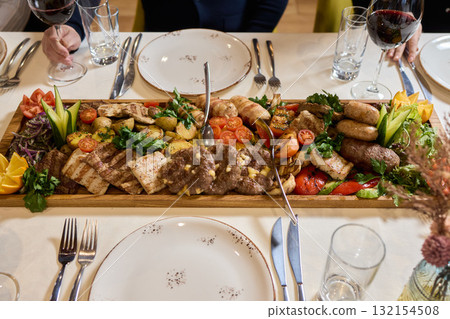 Indulge in an exquisite gourmet platter perfectly paired with a fine red wine selection Indulge in an exquisite gourmet platter perfectly paired with a fine red wine selection 132154508