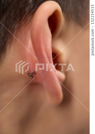 Professional Piercing Process A detailed closeup view showcasing the art of Ear Piercing 132154515