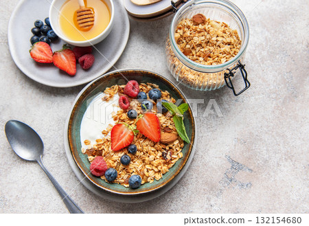 Granola bowl with yogurt berries and honey Granola bowl with yogurt berries and honey 132154680