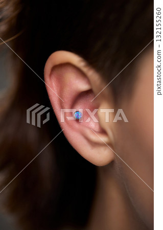 Professional Piercing Process A detailed closeup view showcasing the art of Ear Piercing Professional Piercing Process A detailed closeup view showcasing the art of Ear Piercing 132155260