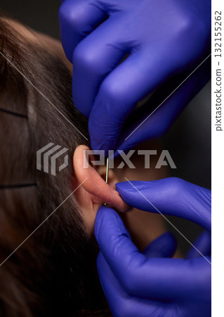 Professional Piercing Process A detailed closeup view showcasing the art of Ear Piercing 132155262