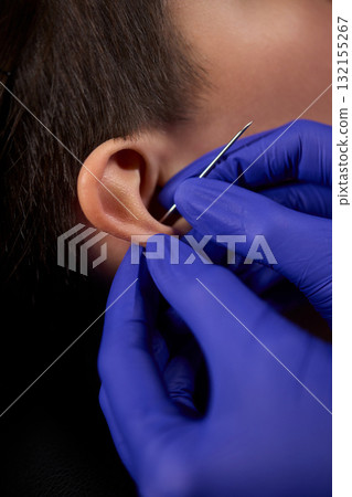 Professional Piercing Process A detailed closeup view showcasing the art of Ear Piercing 132155267