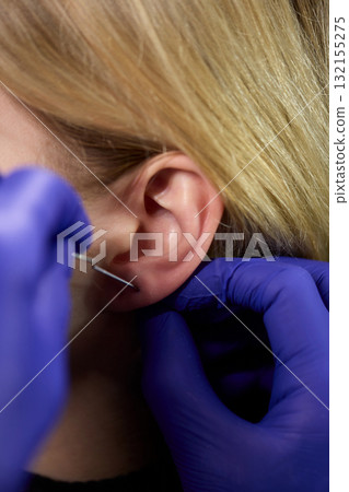 Professional Piercing Process A detailed closeup view showcasing the art of Ear Piercing 132155275
