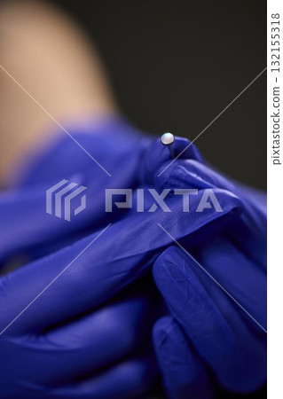 Professional Piercing Process A detailed closeup view showcasing the art of Ear Piercing Professional Piercing Process A detailed closeup view showcasing the art of Ear Piercing 132155318