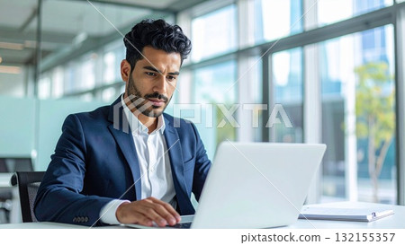 A young foreign man working seriously on a laptop in an office 16:9 size AI-generated material A young foreign man working seriously on a laptop in an office 16:9 size AI-generated material 132155357