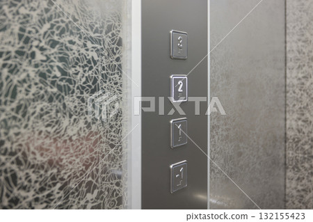 The modern elevator control panel features a display showcasing the current floor number The modern elevator control panel features a display showcasing the current floor number 132155423