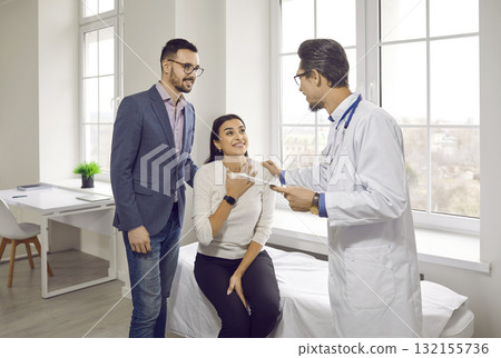 Happy couple thanking doctor for health check up and consultation on IVF treatment Happy couple thanking doctor for health check up and consultation on IVF treatment 132155736