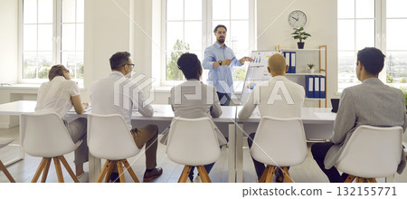 Man couch trainer teaches communicates with a group of adult students using flipboard with charts. 132155771