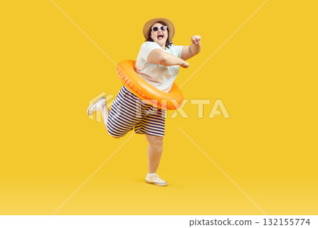 Funny happy overweight woman is having fun at the beach during her summer vacation Funny happy overweight woman is having fun at the beach during her summer vacation 132155774