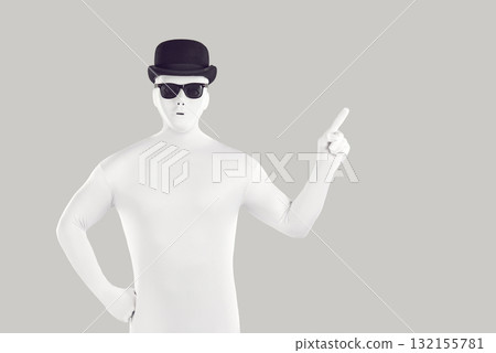 Disguised man dressed in white bodysuit pointing to side with forefinger Disguised man dressed in white bodysuit pointing to side with forefinger 132155781
