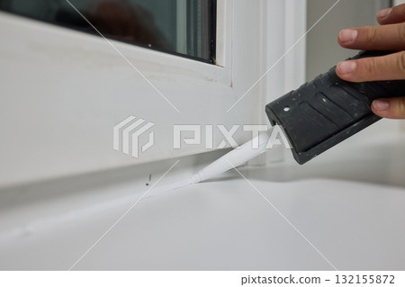 Sealing the corners of windows with caulk for achieving a perfectly neat and polished finish Sealing the corners of windows with caulk for achieving a perfectly neat and polished finish 132155872