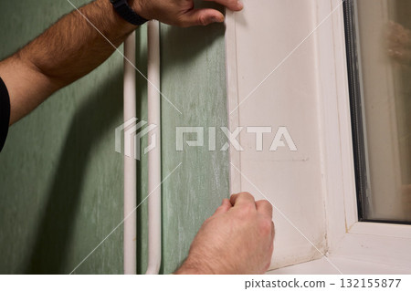 Applying Caulk to Wall Trim in Order to Achieve a Neat and Clean Finish for Your Home 132155877