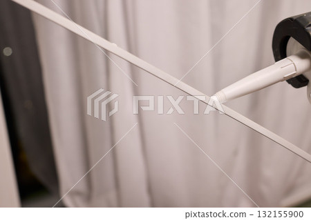 Hand Applying Adhesive with a Caulking Gun for Various Home Interior and Exterior Projects 132155900