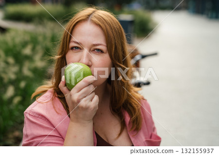 Plus size woman holding green apple. Plus size woman holding green apple. 132155937