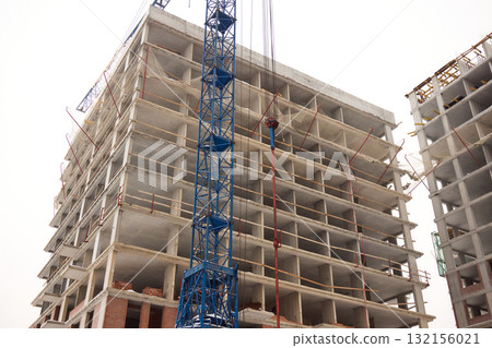 A bustling Construction Site showcasing Cranes, Building Framework, and full activity all around A bustling Construction Site showcasing Cranes, Building Framework, and full activity all around 132156021