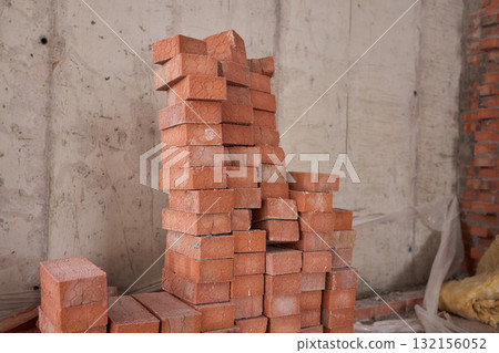 A closeup image of Stacked Red Bricks showcased in a dynamic Construction Environment 132156052