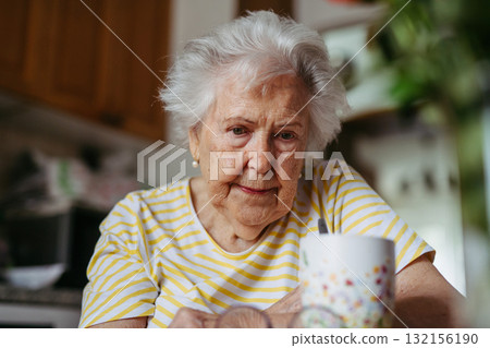 Portrait of worried senior woman crying in kitchen. Portrait of worried senior woman crying in kitchen. 132156190