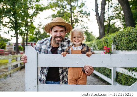 Little boy and father on farm, standing on fence. Little boy and father on farm, standing on fence. 132156235