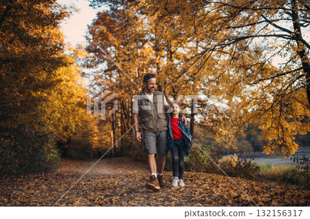 Dad and daughter on walk in autumn nature. 132156317
