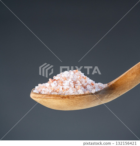 Heap of rose-colored sea salt on rustic wooden utensil, great for kitchen and mineral nutrition images Heap of rose-colored sea salt on rustic wooden utensil, great for kitchen and mineral nutrition images 132156421