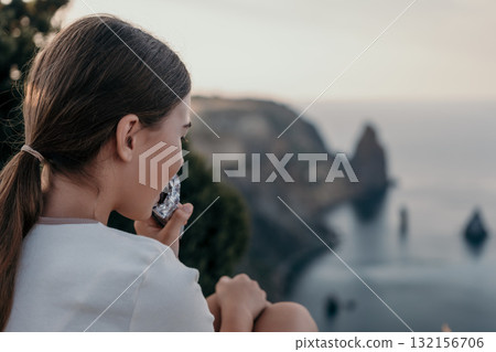Woman Enjoying Snack With a Scenic View 132156706