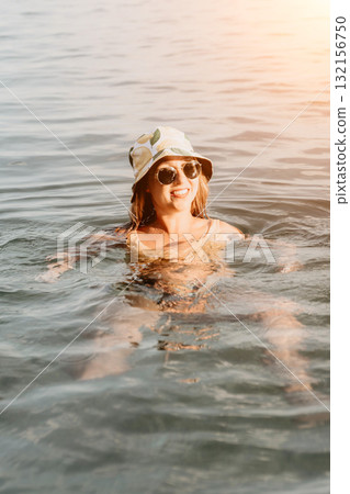 Woman Sunglasses Lake Relaxing - A woman wearing sunglasses floats in a lake. 132156750