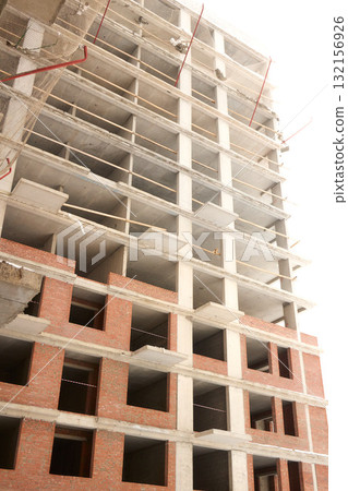 A bustling Construction Site showcasing Cranes, Building Framework, and full activity all around 132156926