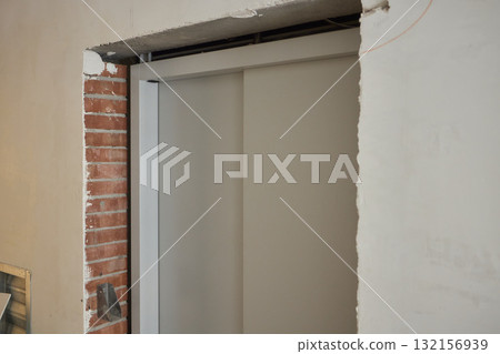 Contemporary interior column design featuring a sophisticated blend of gray and brick elements Contemporary interior column design featuring a sophisticated blend of gray and brick elements 132156939