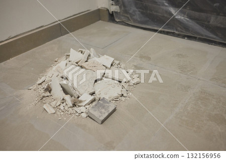 Construction debris is scattered across the floor after the recent renovation work Construction debris is scattered across the floor after the recent renovation work 132156956