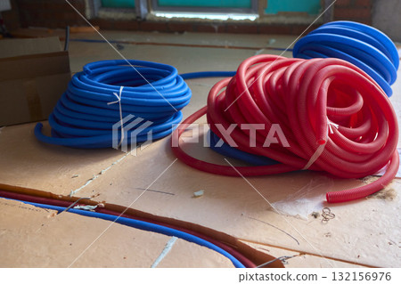 Vibrantly Colored Coiled Hoses Ideal for Plumbing Needs or Electrical Applications Vibrantly Colored Coiled Hoses Ideal for Plumbing Needs or Electrical Applications 132156976