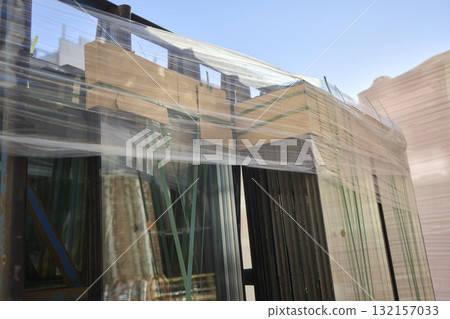 Transparent Glass Panels Artfully Stacked Together, Showcasing Unique Reflections 132157033