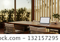 White screen laptop with coffee and books on table and steel armchairs in dining hall a restaurant. 132157295