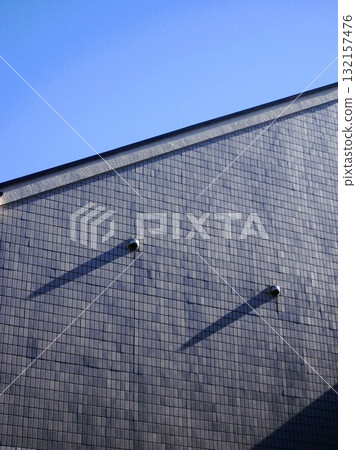Black tile wall and winter blue sky Black tile wall and winter blue sky 132157476