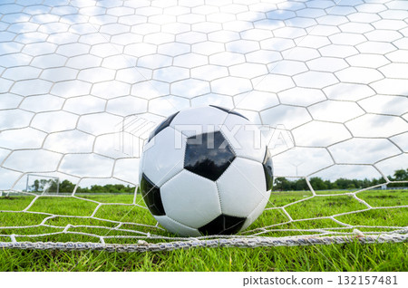 Footballs on the field and goal nets in a large stadium 132157481