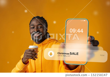 Man holding coffee and smartphone showing Christmas sale notification Man holding coffee and smartphone showing Christmas sale notification 132158147