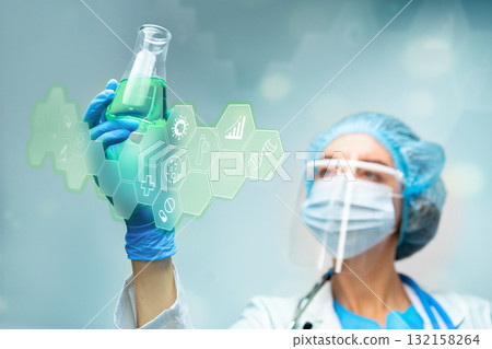 Scientist examines green liquid in flask with digital icons in laboratory setting 132158264