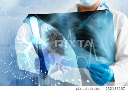 Medical professional examines lung x-ray in clinic setting during daytime for patient analysis 132158267